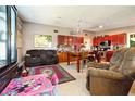 Open-concept living area featuring a kitchen with warm wood cabinets and an adjacent lounge at 2504 Caribbean Ct, Orlando, FL 32805