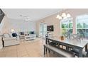 Open concept living room and dining area with a modern table and access to the outdoor patio at 2952 Lucayan Harbour Cir # 105, Kissimmee, FL 34746
