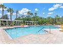 Resort-style pool area with pergolas, seating, and palm trees at 3561 Conroy Rd # 216, Orlando, FL 32839