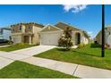 Well-maintained home with a two-car garage, and landscaped front yard under a bright blue sky at 3624 Sungrove Cir, Sanford, FL 32771