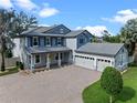 Beautiful exterior of a two-story home with a three-car garage and a paver driveway at 3865 W Stillwood Ln, Lake Mary, FL 32746