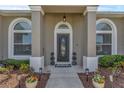 An inviting front entrance with decorative plants, updated lighting, and a modern front door design at 445 Oakland Park Blvd, Port Orange, FL 32127