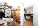A cluttered living room with geometric wallpaper and tile flooring at 5262 Lescot Ln, Orlando, FL 32811
