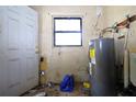 Utility room with outdated hot water heater and concrete block walls at 5262 Lescot Ln, Orlando, FL 32811