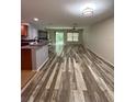 Spacious living room boasts stylish wood-look flooring and plenty of natural light at 626 Old Pine Ct, Sanford, FL 32773