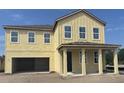 Newly constructed home featuring an inviting front porch and an attached two-car garage in a developing neighborhood at 710 Junonia Blvd, New Smyrna Beach, FL 32168
