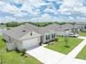 Charming single Gathering home with a manicured lawn, landscaping, and a two car garage at 715 Auburn Grove Ct, Auburndale, FL 33823