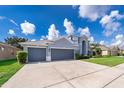 Attractive two-story home with a three-car garage and well-maintained front yard at 7263 Winding Lake Cir, Oviedo, FL 32765