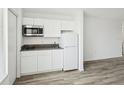 Modern kitchen with white cabinets, gray countertop, stainless steel microwave, and new appliances at 935 S Atlantic Ave # 302, Daytona Beach, FL 32118