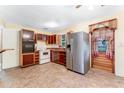Functional kitchen features stainless steel refrigerator and white appliances at 944 Essex Rd, Daytona Beach, FL 32117