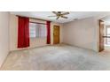 Spacious living room featuring neutral carpet, window, and ceiling fan at 944 Essex Rd, Daytona Beach, FL 32117