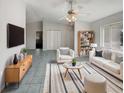 Bright living room boasts stylish furniture, tile flooring, and a contemporary ceiling fan at 10350 Sw 62Nd Terrace Rd, Ocala, FL 34476