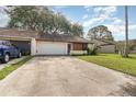 Single-story home with an attached garage, driveway, and front yard at 109 Long Leaf Pine Cir, Sanford, FL 32773