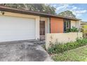 Home exterior with garage, driveway, front door and small garden at 109 Long Leaf Pine Cir, Sanford, FL 32773