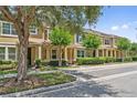 Townhome with a landscaped yard and mature trees along a well-maintained street at 11213 Grander Dr, Windermere, FL 34786