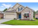 Single-Gathering home with stone facade, manicured lawn, blue front door and shutters at 11225 Cypress Trail Dr, Orlando, FL 32825