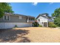 Exterior view of home featuring gravel driveway and white garage doors at 1308 S Pennsylvania Ave # 3, Winter Park, FL 32789