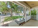 View from the covered front porch with trees draped in moss at 13146 Odyssey Lake Way, Orlando, FL 32826