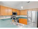 Updated kitchen features stainless steel appliances and ample counter space at 13146 Odyssey Lake Way, Orlando, FL 32826