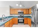 Kitchen features stainless steel appliances and solid countertops at 13146 Odyssey Lake Way, Orlando, FL 32826
