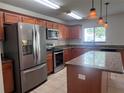 Updated kitchen featuring stainless steel appliances, island and beautiful granite countertops at 1325 Bella Coola Dr, Orlando, FL 32828