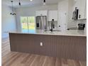 Kitchen with stainless steel appliances, white cabinets, and island with seating at 16494 Sw 54Th Court Rd, Ocala, FL 34473
