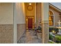 Inviting front porch with tile flooring, seating, and decorative planters at 1905 Old Club Pt, Maitland, FL 32751