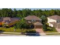 Inviting two-story home with mature trees, lovely yard, and convenient two car garage at 206 Yellow Snapdragon Dr, Davenport, FL 33837