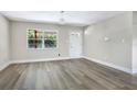 Bright living room with new gray wood floors, a large window, and a fresh coat of neutral paint throughout at 2536 Nw 3Rd Ave, Ocala, FL 34475
