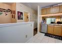 Open-concept kitchen with wood cabinets, granite countertops, and stainless steel dishwasher at 2935 Greenwood Springs Loop, Lake Mary, FL 32746