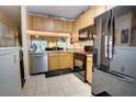 Cozy kitchen featuring wood cabinets, granite countertops, and stainless steel dishwasher at 2935 Greenwood Springs Loop, Lake Mary, FL 32746