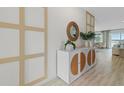 Hallway featuring decoratively paneled wall, white credenza with mirror and contemporary accents at 3318 Arch Ave, Ormond Beach, FL 32174