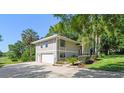 Two-story home with a two-car garage, neutral paint and well-maintained landscaping at 33925 Highland Rd, Leesburg, FL 34788
