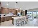 Open-concept kitchen with a large island, modern appliances, and seamless flow to outdoor living at 3814 Blue Vale Dr, Davenport, FL 33837