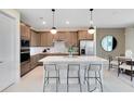 Modern kitchen with stainless steel appliances, an island, and stylish pendant lighting at 3814 Blue Vale Dr, Davenport, FL 33837