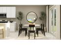 Cozy dining area with modern black chairs, a round table, contemporary decor and natural light at 459 Puma Loop, Groveland, FL 34736