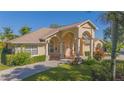 Attractive single-story home featuring a columned front porch and well-maintained landscaping, exuding curb appeal at 4735 Chelsea Ct, Kissimmee, FL 34744