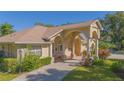 Attractive single-story home featuring a columned front porch and well-maintained landscaping, exuding curb appeal at 4735 Chelsea Ct, Kissimmee, FL 34744