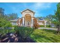 Inviting single Gathering home with a columned entrance and colorful shrubs, offering a warm and welcoming curb appeal at 4735 Chelsea Ct, Kissimmee, FL 34744