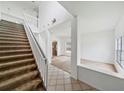 Inviting entryway with high ceilings, tile flooring, carpeted stairs, and an open layout at 4785 Cumbrian Lakes Dr, Kissimmee, FL 34746