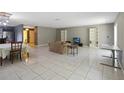 An open-layout living room features tile floors and a view of the kitchen and dining area at 4806 Gallant Ln, Orlando, FL 32821