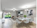 Spacious living room featuring wood floors, neutral walls, and sliding glass doors to the outside patio at 4878 Tangerine Ave # 4878, Winter Park, FL 32792