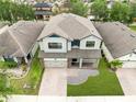 Aerial view of the property showing its well-maintained roof, landscaping, and proximity to neighboring homes at 5116 Sorrento W Blvd, St Cloud, FL 34771