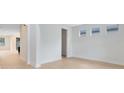 Bright, empty living room with hardwood floors and three windows providing natural light at 5116 Sorrento W Blvd, St Cloud, FL 34771