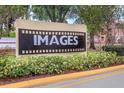Sign for the community with manicured landscaping around it at 5291 Images Cir # 301, Kissimmee, FL 34746