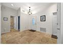 Bright foyer with tile flooring, a white front door, and views of the hallway and bathroom at 602 Nighthawk Cir, Winter Springs, FL 32708