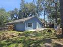 This back exterior features a cement patio and ample yard space at 6436 Fig Leaf St, Magnolia Square, FL 34771