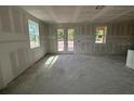 Unfinished living room with natural light showcases an open floor plan, ready to be customized with drywall at 706 Junonia Blvd, New Smyrna Beach, FL 32168