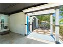 View of a modern entryway with block wall construction, dark trim accents, and blue door at 7712 Hoosier Pl, Orlando, FL 32807