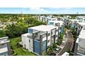 Stunning aerial view of modern townhouses with private balconies and lush landscaping in a well-planned community at 7770 Sandy Ridge Dr # 234, Reunion, FL 34747